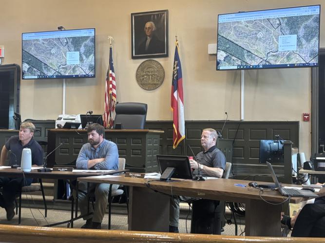 Jay Paul (from left), chair of the Board of Commissioners, and commissioners Will Brown and Tracy Norman, listen to speakers during the commission meeting on Monday at the courthouse. The commissioners unanimously approved a data center ordinance. (ANDY JOHNSTON/THE OGLETHORPE ECHO)