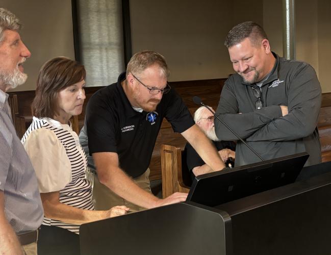 Tom Gresham, Amy Forrester, Josh Robinson and Jason Lewis work on getting the video screens running on Sept. 14, 2026. (ANDY JOHNSTON/THE OGLETHORPE ECHO)