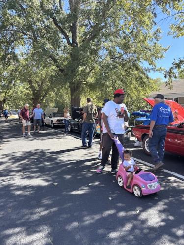 Spectators of all ages enjoy the vehicles at the Firefly Cruise In on Sunday in Lexington. More than 40 cars, trucks, motorcycles and tractors participated in the event. (Maura Potvin/The Oglethorpe Echo)