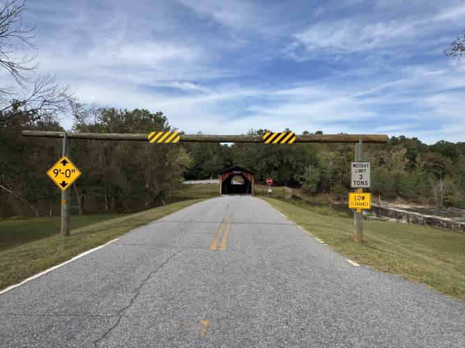 Signage at the entrance to the covered bridge at Watson Mill Bridge State Park lets drivers know if their vehicles are too tall or too heavy for the bridge, which was built in 1885. The park also is developing a nine-acre area into a “pollinator walking trail.” (Photo/Matthew Herren)