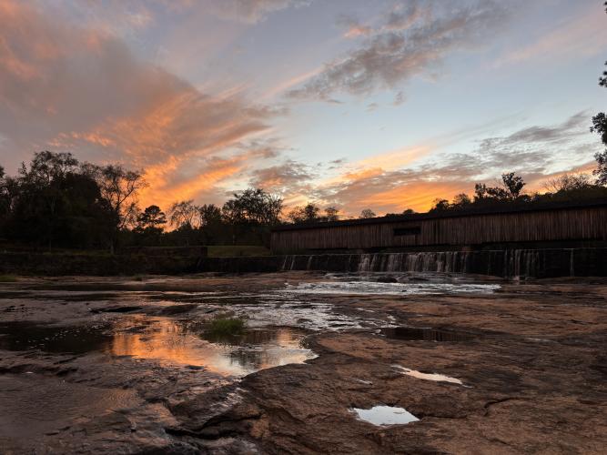 This sunset created an idyllic setting at the covered bridge at Watson Mill Bridge State Park on Oct. 5. Park superintendent John Mark Shelnutt and senior ranger Clint Wilkes have made several improvements to the park. (Photo/Wesley Webb)