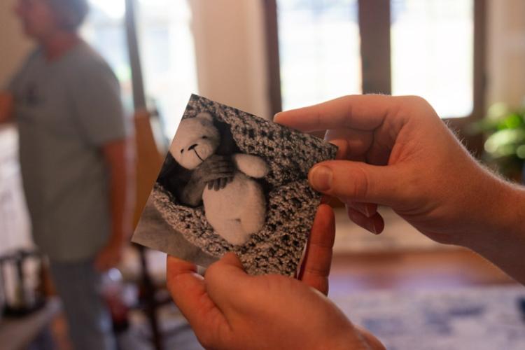 Andy Paul holds a picture of his son Jonah holding his teddy bear at the family’s Lexington home last Thursday. The Pauls have multiple mementos of their son Jonah throughout their house. (SARAH ROPER/THE OGLETHORPE ECHO)
