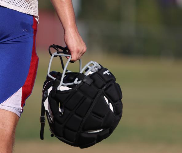 An Oglethorpe County football player holds his helmet with a Guardian Cap. All OCHS players received Guardian Caps as part of their uniform, and they are encouraged to wear them to help reduce the risk of concussions. (Sydney Jarrard/The Oglethorpe Echo)