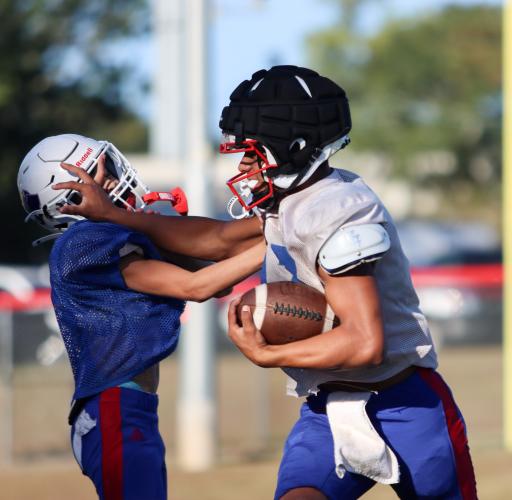 Cooper Davenport runs the ball at practice while wearing a Guardian Cap. Davenport is a running back and sustains a lot of high-impact and high-speed hits, so he opted to wear a Guardian Cap during practices and games for more head protection. (Sydney Jarrard/The Oglethorpe Echo)