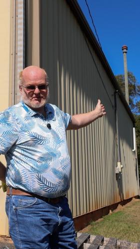EMA director Douglas Spencer motions toward the tornado siren at the Lexington Volunteer Fire Department earlier this month. The siren can only be switched on from inside the department, and is tested 2-3 times per year. (SARAH ROPER/THE OGLETHORPE ECHO)