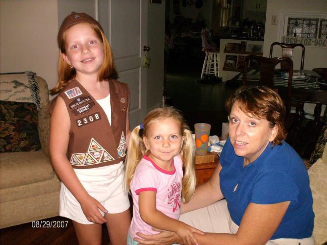 Ansley Land, wearing her Girl Scout vest, is shown with her sister Carrie Tweedell and mother DeLynda Tweedell in their family room in 2007. DeLynda was the troop leader for both Land and Carrie Tweedell during their time in Girl Scouts. (Submitted Photo)