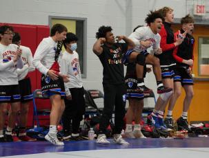 The Oglethorpe County High School wrestling team celebrates after a win against Coosa in a match on Saturday.  (Sarah White/The Oglethorpe Echo)