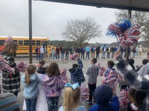 Oglethorpe County Primary School students show off their poster during a sendoff for the OCHS wrestling team. (Meredith Boyd/The Oglethorpe Echo)