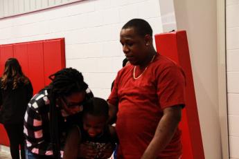 Reggie Mattox, who scored 20 of his team’s 24 points, and his family hug after the Oglethorpe Recreation Department Championship game