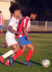 Erick Lopez-Salazar keeps the ball away from a Richmond County Technical Career Magnet School player in the Patriots' 9-0 win on Feb. 25. (Ralph Maxwell/ Submitted Photo)