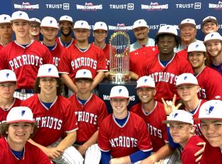 The Oglethorpe County baseball team had its photo taken with the 2021 World Series Trophy at a doubleheader at Elbert County last week. The Atlanta Braves won last year’s World Series. (SUBMITTED PHOTO)
