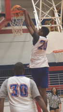 Coach Maurice Freeman shows off his vertical by dunking in the community basketball fundraiser games at OCHS on March 24. (Ralph Maxwell/Submitted Photo)