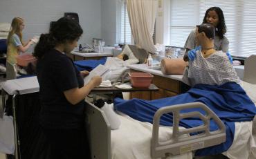 OCHS students practice for their CNA certification, which they took earlier this month. All 24 of teacher Erin Bunch’s class passed the test earlier this month. (Photo/Darden Hearn)