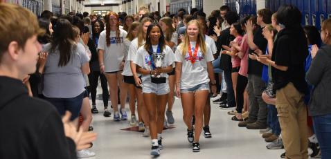 Jayda Jones (left) and Maddie Williams lead the girls track team through Oglethorpe County Middle School during the first stop on their state championship parade on May 17. The team stopped at all three feeder schools and the central office before a celebratory lunch. (Photo/Thomas Ehlers)