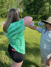 Oglethorpe County High School’s Keaton Gaines listens to an instructor during an archery class at the Natural Resources Conservation Workshop last month. (Submitted Photo)