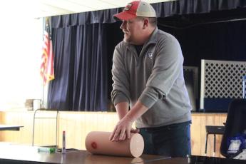 Jason Lewis demonstrates packing a wound for staff members of the ASPIRE program at a Stop the Bleed training session at Oglethorpe County Primary School on Nov. 7. The training helps educate county teachers and officials on how to stop significant bleeding in case of injury. (Emily Garcia/The Oglethorpe Echo)