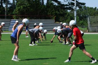 The Oglethorpe County football team lines up to run a play during practice on Monday morning. The Patriots can begin practicing in pads on July 31. (LANDEN TODD/THE OGLETHORPE ECHO)