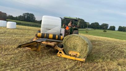 Cory Clements bails and wraps hay on John Robertson’s farm in the Smithonia Community in 2022. Oglethorpe County was the 10th largest hay producing county in the state in 2021. (Dink Nesmith/ The Oglethorpe Echo)