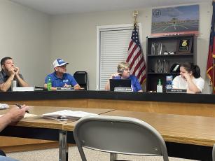 Oglethorpe Board of Education members (from left) Guillermo Camacho, Tim Poole, Beverley Levine and Becky Soto discuss the approval of the new rate. The board voted 5-0 to approve the rate, while Susan Robinson had a planned absence. (Photo/Caleb Baldwin)