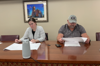 Morgan Robinson and Robert Drew prepare for their meeting. Each member is given zoning property maps to visualize each zoning request. (Grace Mains/The Oglethorpe Echo)