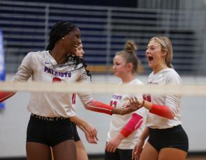 Junior Kenzie Henderson and senior Madi Kelley celebrate after Henderson gets a kill in Oglethorpe County's first-round state playoff win over Rabun County on Wednesday, Oct. 18, 2023, in Lexington, Georgia (Photo/Cassidy Hettesheimer).