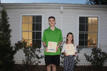 Ninth-grader James Adams (left), who achieved a perfect score on an Algebra I End of Course Test after completing a summer class through Georgia’s Virtual School. Third-grader Catherine Yauck (right), who won first place in the Plains Peanut Festival Postcard Contest. (Photo/Caleb Baldwin)