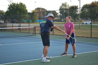 Tennis pro Lloyd Martin teaches student John Utley, who is 12, proper swing techniques during a recent practice at Bryan Park. There are three tennis sessions throughout the year at the park. (Jordyn Gershoni/The Oglethorpe Echo)