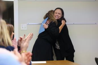 Oglethorpe County Primary and Elementary School principal Katie Baldwin hugs special education parapro Toni Evans after presenting her with the OCES Classified Employee of the Year award at the board of education meeting in Lexington, Georgia, on Tuesday, Nov. 7, 2023. Three of the county's four Classified Employees of the Year were honored at the November Board of Education meeting. (Photo/Cassidy Hettesheimer)