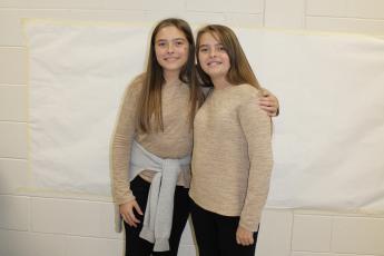 Rileigh (left) and Raina Giles pose together for twin day. The two seventh graders are actual twin sisters. (Photo/Caleb Baldwin)