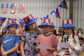 Second graders recite the poem "If You Give a Veteran a Thank You." Jennifer Kimbel's group of students were the openers for the performance. (Caleb Baldwin/The Oglethorpe Echo)