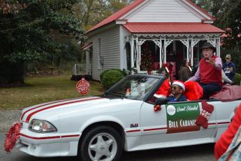 Grand marshal and Maxeys resident Bill Cabaniss passes by in his decorative parade “float,” a Ford Mustang. Each float in the Maxeys Christmas Parade was decorated to match a theme. (Grace Mains/The Oglethorpe Echo)
