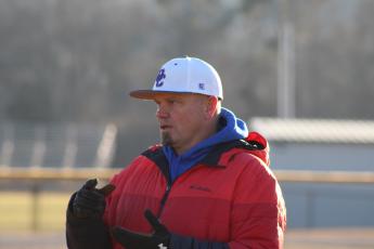 Head baseball coach Mike Campbell speaks with a player during a recent practice. Campbell is in his first season as head coach at Oglethorpe County. (Photo/Owen Warden)