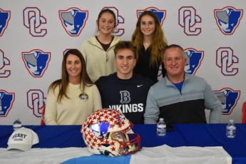 OCHS running back Jake Turner signed a letter of intent to play football at Berry College on Feb. 14. He’s joined by his mom Kristina, sisters Elin and Georgia, and dad John at the OCHS cafeteria. (Submitted Photo)