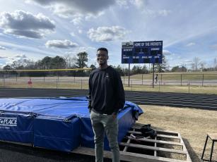 Maurice Freeman, a Patriot state champion in the high jump in 2012, now coaches the boys track team.