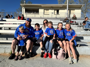 Dominic (with beard) and Cassandra Fabrizio (fourth from left) and their children (from left) Austin, Wyatt, Colton and Ryley (right), and friend Harper Bondie (second from right) watch the Oglethorpe County boys soccer team play on Rec Night.