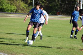 Oglethorpe County's Sergio Alio dribbles away from a Valdosta defender in a 2-1 loss to the Wildcats on April 5. The Patriots rebounded from the loss with a 2-0 win over Jasper County on Monday night. (Photo/Owen Warden)