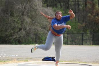 Zy’Kieria Edwards works on throwing the shot during Oglethorpe County track practice last week. She finished fifth in Class A Division I last spring and has a goal to throw at least 40 feet this year. (Samuel Higgs/The Oglethorpe Echo) 