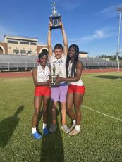 Denim Goddard (from left), Landon Mallonee and Kenzie Henderson show off the high point trophies they won at the Region 5-A Division I meet at Jasper County on April 25. The boys and girls track teams will compete at the sectionals next week. (Submitted Photo)