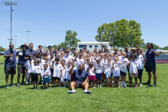 Campers and staff members pose for a photo after the second annual Bonds Movement Youth Football Camp at Oglethorpe County High School in Lexington on Saturday. Bonds, an OCHS alum who created and runs the camp, currently plays for South Carolina State. (Ethan Greene/The Oglethorpe Echo)