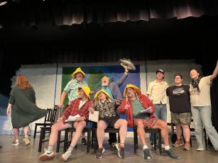 The cast of “Come From Away” rehearses a scene while on stage at the Historic Crawford School on June 11. Like in the original Broadway version, rows of chairs are used to simulate rows of seats on an airplane during the story that takes place during Sept. 11, 2001. (Sarah Nanos/The Oglethorpe Echo) 