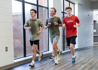Luke Holbrooks (from left), Rex Allen and John Wanager practice with the cross country team inside OCHS on Monday. Many of the team’s practices this month have been indoors due to high temperatures and humidity. (Ethan Greene/The Oglethorpe Echo)