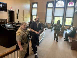 Kim Williams, a deputy with the Oglethorpe County Sheriff’s Office, escorts Michael Thomas Dusch from the courthouse after he was sentenced to life for the murder of David John Stewart in Arnoldsville last year. He pleaded guilty to all nine counts. (Dink NeSmith/The Oglethorpe Echo)