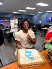Former OCHS and Athens Academy running back PayTon Xavier “Zay” Prince celebrates at his send-off party with a cookie cake at The Local Spot in Crawford on July 28. He has signed to play football at the University of the Cumberlands. (Submitted Photo)