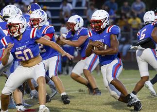 Oglethorpe County sophomore running back Zion Pass (4) takes a handoff against Washington-Wilkes on Sept. 4. Pass leads the Patriots with 207 yards rushing. (Zachary Krausman/The Oglethorpe Echo)