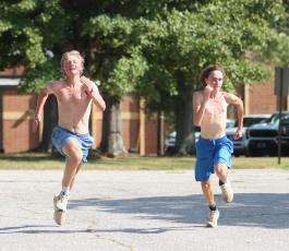 Junior Rex Allen (left) sprints with sophomore Julian George at the end of cross country practice at OCHS on Friday. It was one of the few times OCHS runners have been able to train outside due to extreme heat and high wet bulb temperatures. (SYDNEY JARRARD/THE OGLETHORPE ECHO)