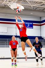 Naomi McPeake skies for a shot in front of teammates Azalee Ring (22) and Hayley Matthews during a recent match at OCHS. The Patriots play Jackson County and Cedar Shoals at Cedar Shoals on Thursday. (Photo/Ty Johnston)