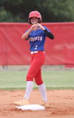 Senior Khloe Eidson flashes a heart to the dugout after hitting a double at the in a victory over Putnam County last month. Eidson, a shortstop, is one of three seniors on the OCHS softball team. (SYDNEY JARRARD/THE OGLETHORPE ECHO)