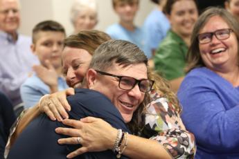 Darryl Brese hugs OCMS Assistant Principal Alecia Cooper after he's been announced as the District Teacher of the Year (Photo/Walker Durham).