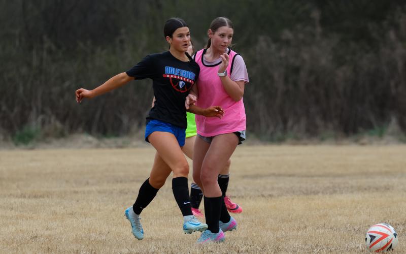 Khloe Eidson (left) and Kiley Paul (right) both fighting for a chance to get the ball. Both girls play with strong passion and care for their teammates and soccer. (Addison Simmons/The Oglethorpe Echo)
