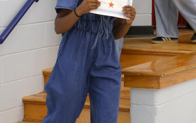 Oglethorpe County High School girls basketball player Jaliyah Glenn smiles with her award of recognition at the OCHS winter sports ceremony on March 5, 2026. (Addison Simmons/The Oglethorpe Echo)